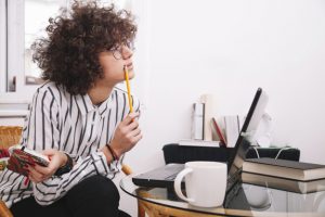 teenager-thinking-near-laptop_23-2147777312